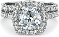 Diamond engagement ring with a cushion-cut center stone and pavé double band