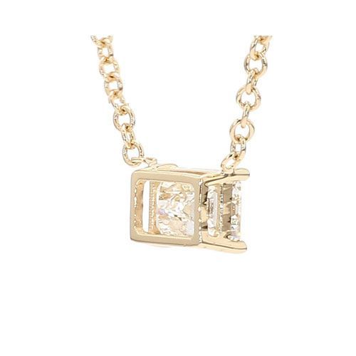Gold necklace with a clear rectangular gemstone pendant on a white background