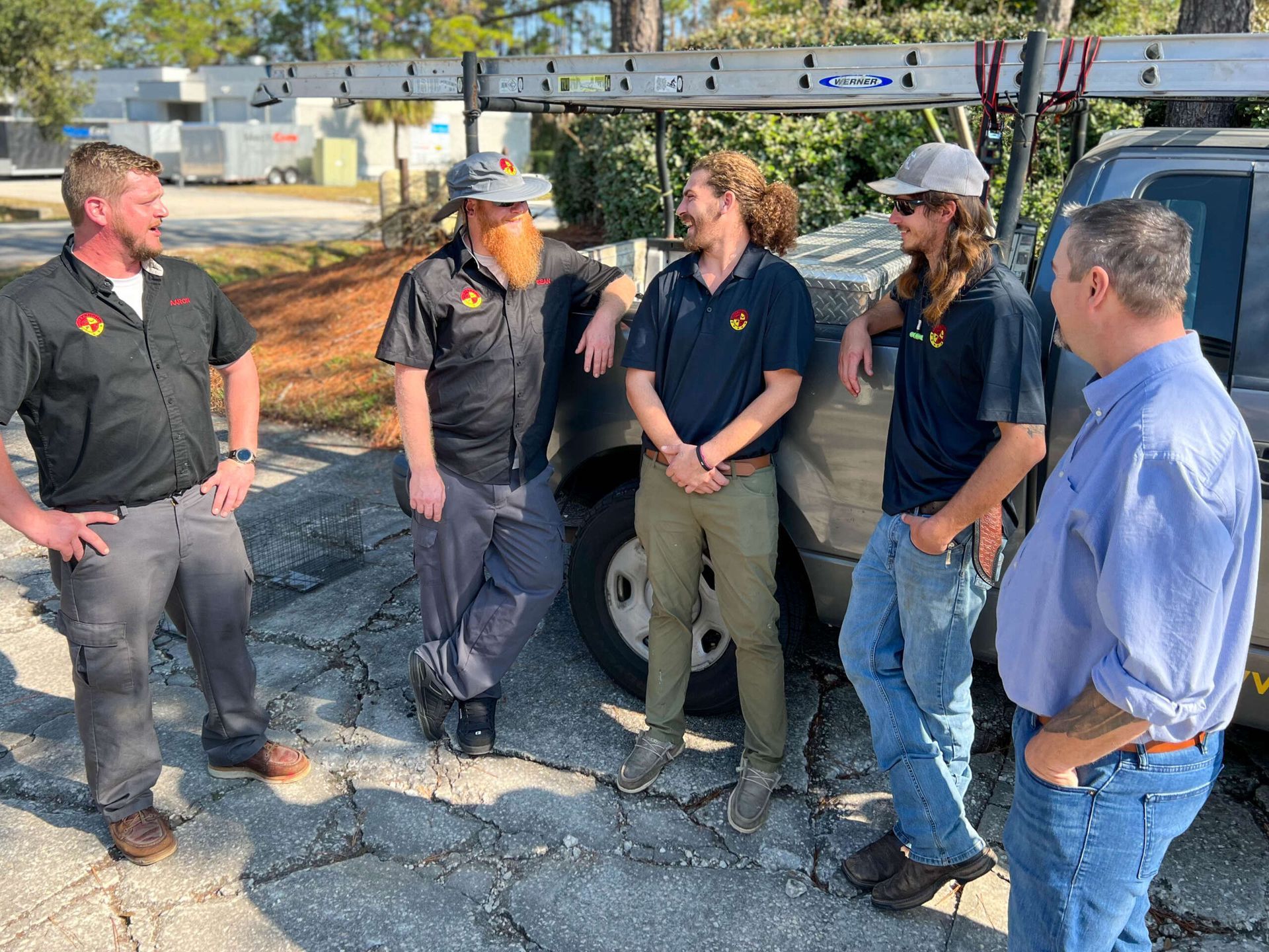 A Group Of Men Standing Next To A Truck — Jacksonville, FL — CritterPro Inc.