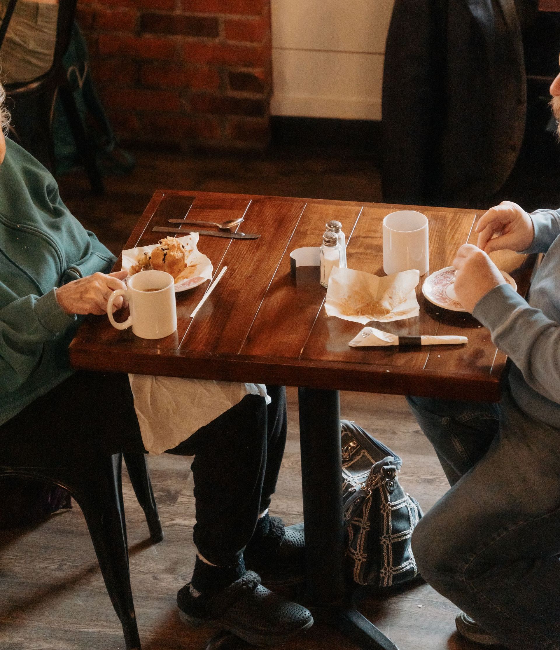 Man and woman share specialty coffee and homeade pastries at local coffee shop and cafe in Mount Vernon Ohio
