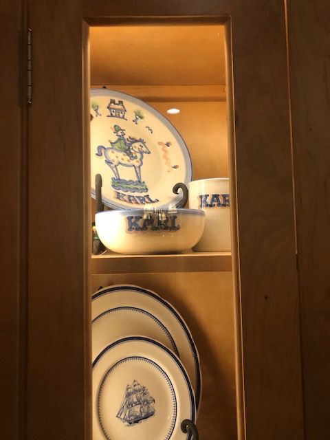 Wooden cabinet with blue-and-white plates and bowls on shelves