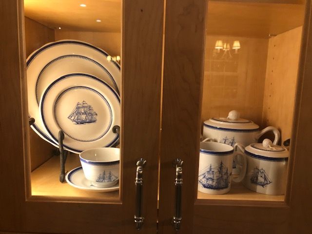 Blue-and-white china set displayed in a wooden cabinet