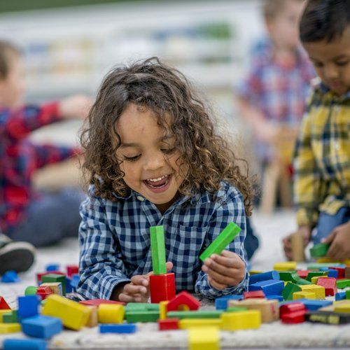 Happy Kid Playing With Shape Blocks — Kankakee, IL — Lasting Impressions Learning Centers Happy Kid Playing With Shape Blocks — Kankakee, IL — Lasting Impressions Learning Centers