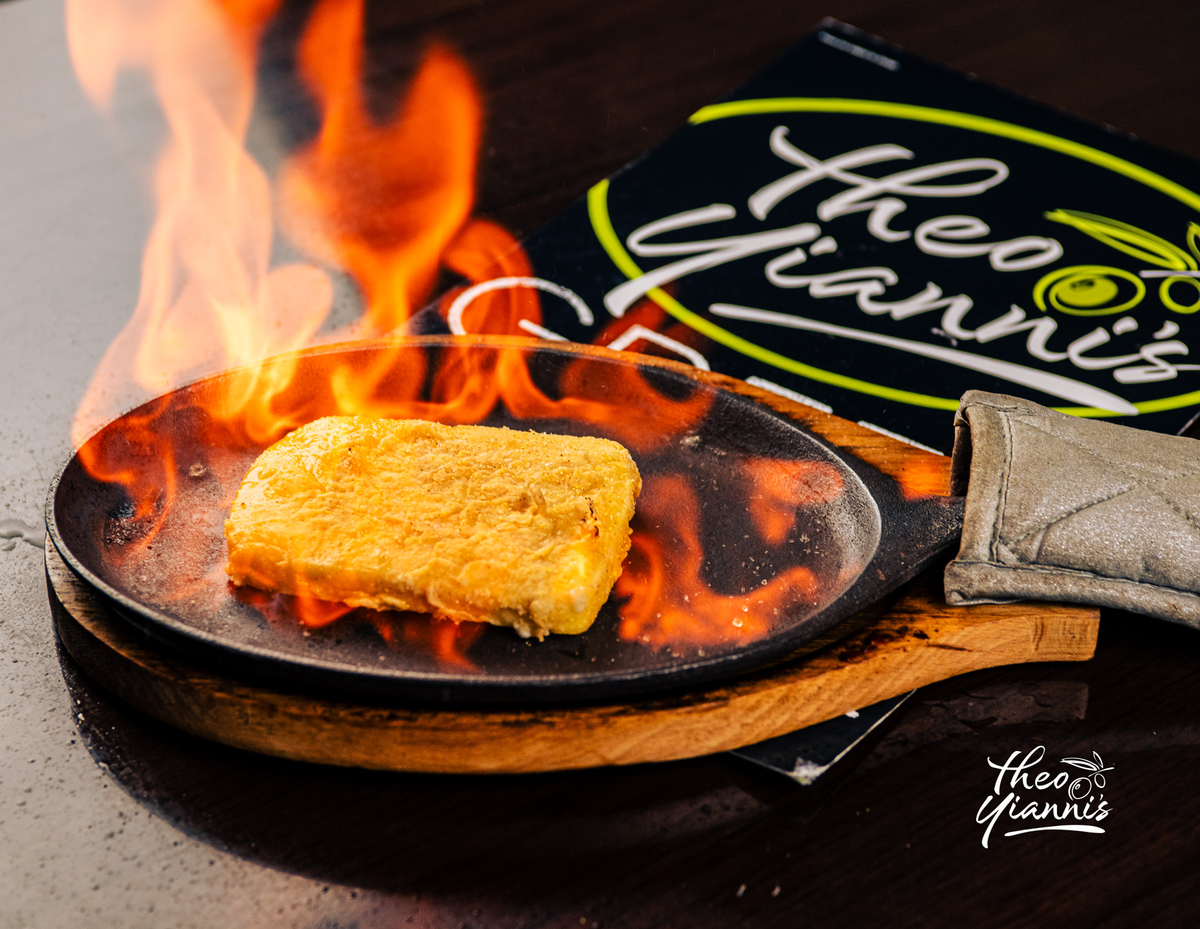 Flaming saganaki, Greek cheese set on fire in a cast-iron pan at Theo Yianni's