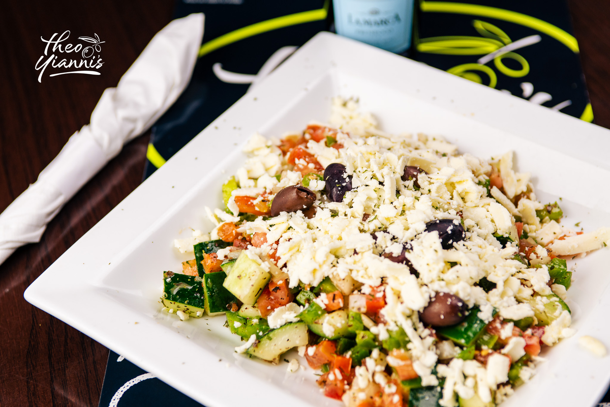 Greek village salad topped with crumbled feta and Kalamata olives