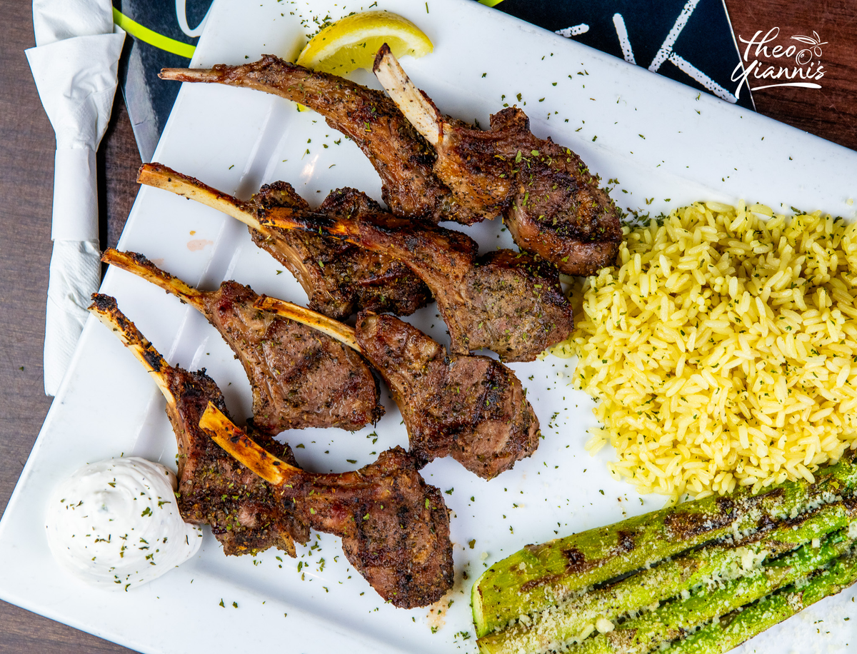 Grilled lollipop lamb chops with yellow rice, asparagus and tzatziki
