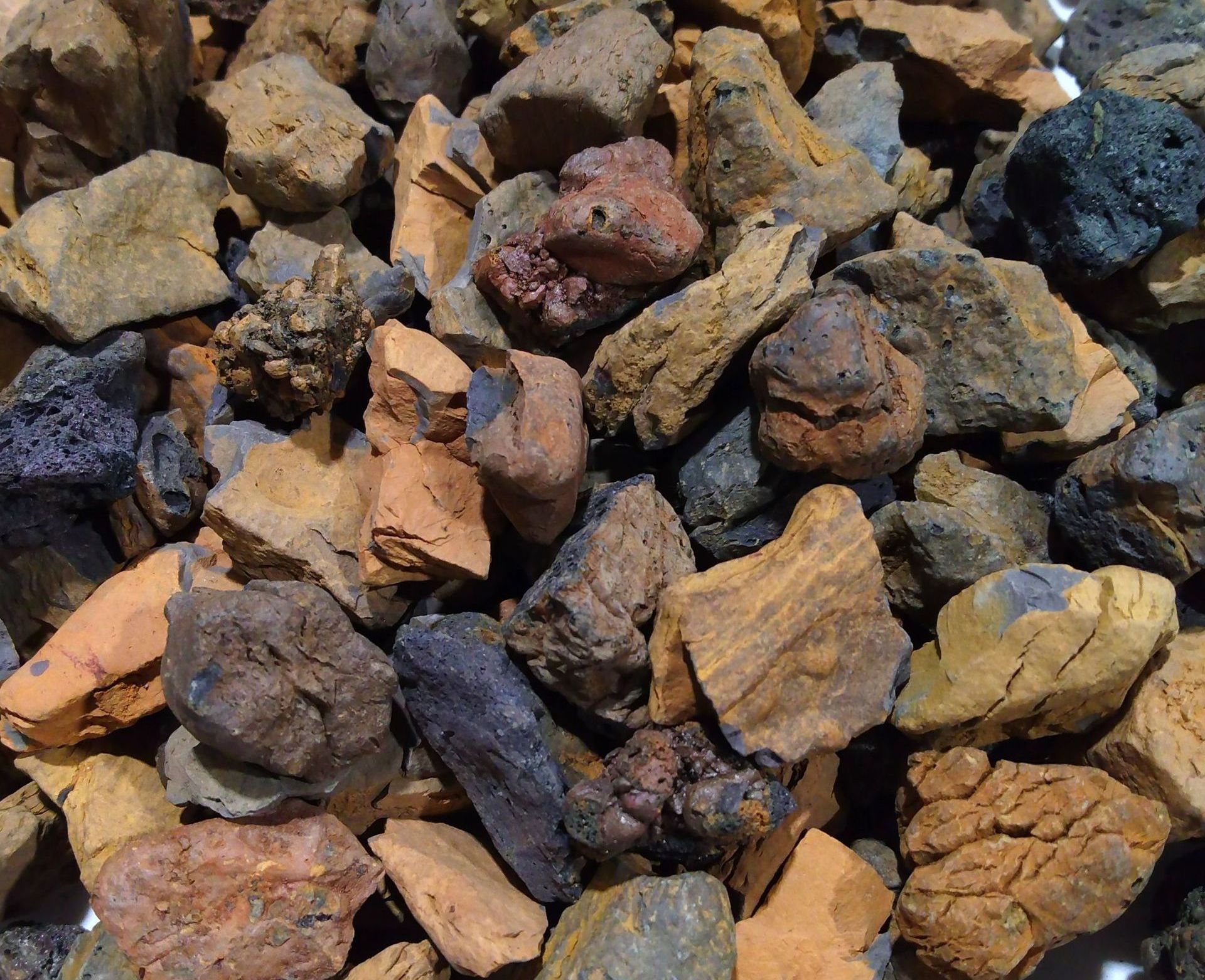 A pile of rocks on a white plate on a table.