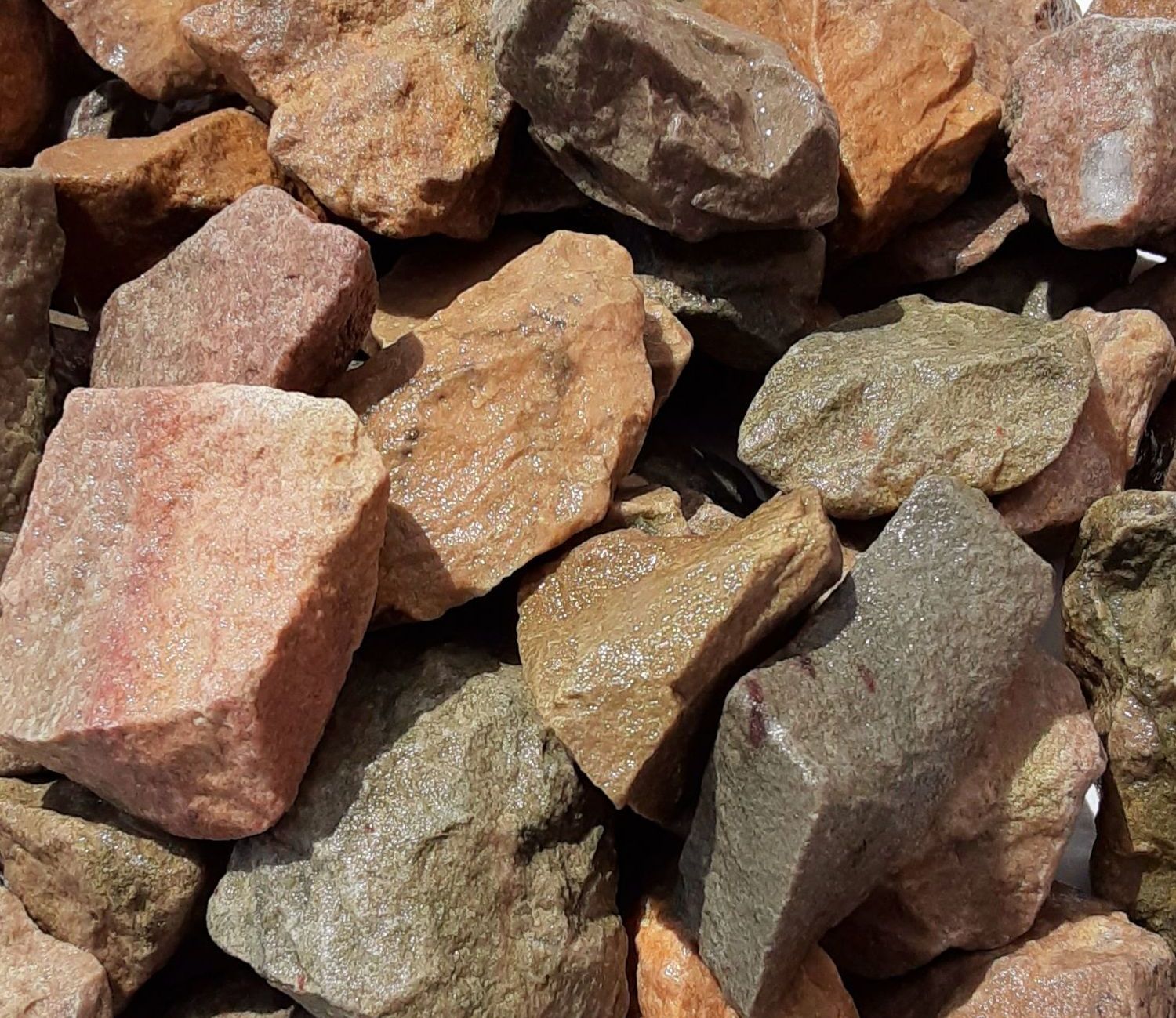 A pile of rocks is sitting on a white surface.