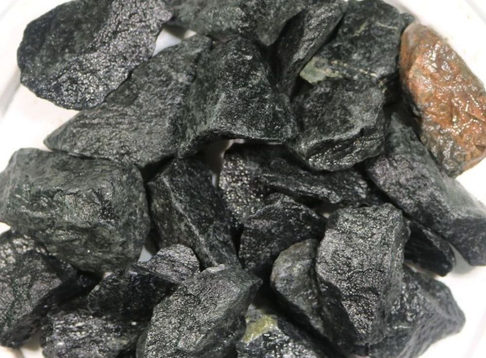 A pile of rocks sitting on top of each other on a black surface.