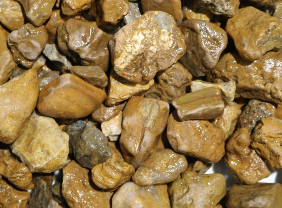 A pile of black gravel with a lot of rocks in it.