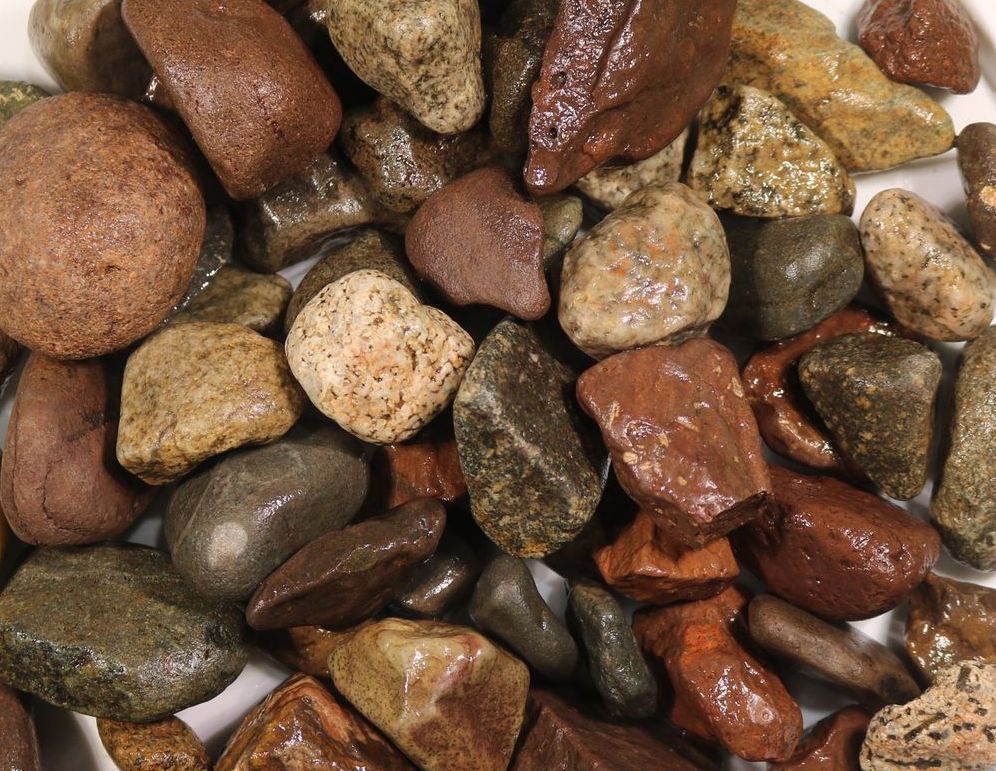 A white plate topped with a pile of rocks
