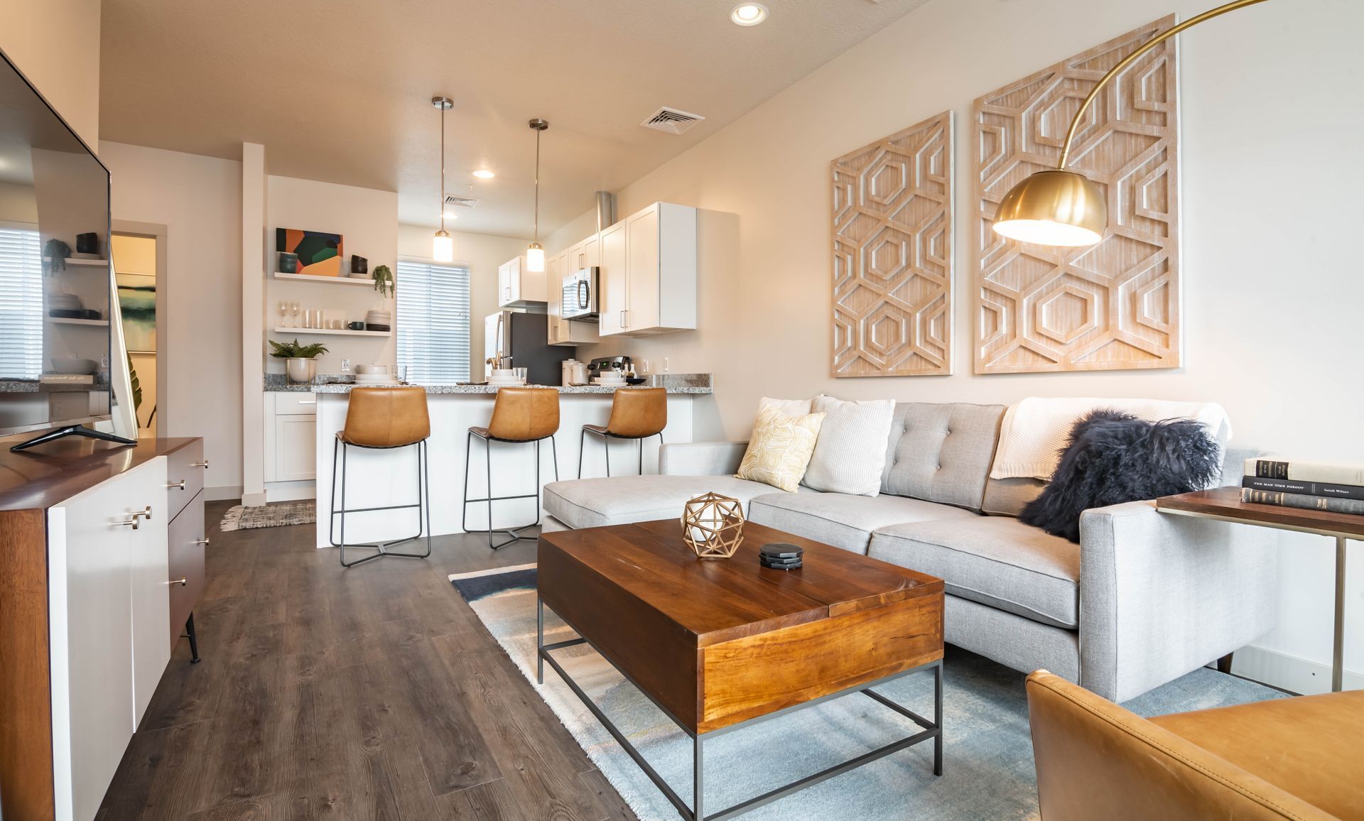 A living room with a couch , coffee table , and television.