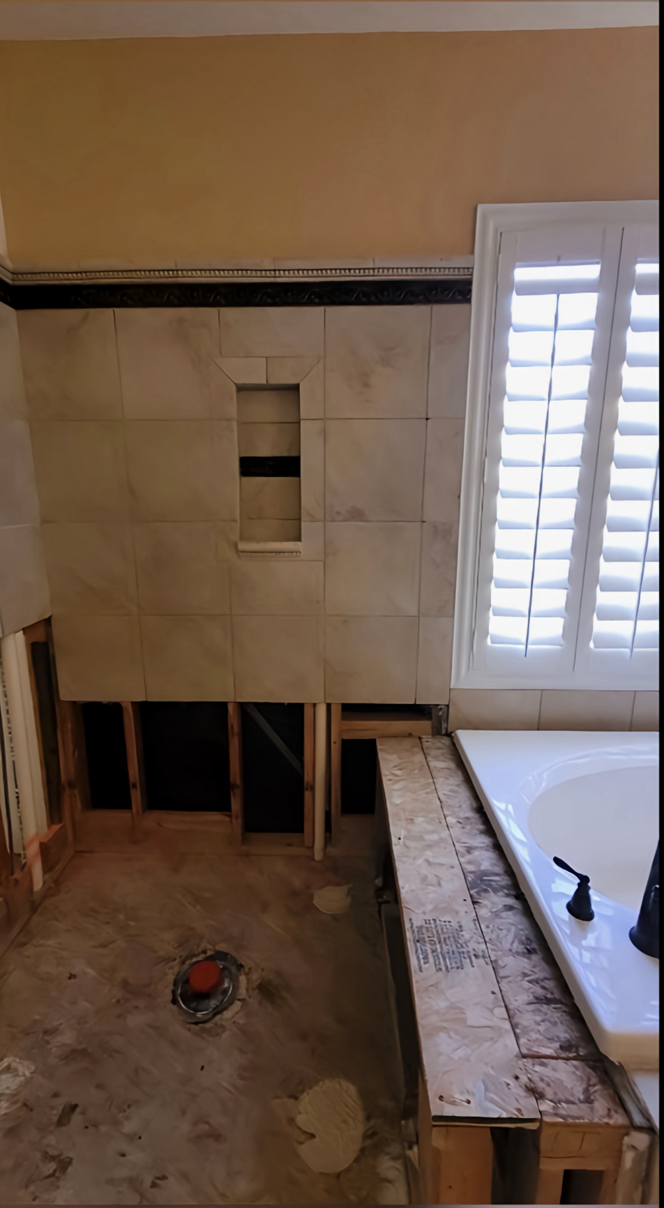 A bathroom sink is being remodeled with a hole in the floor