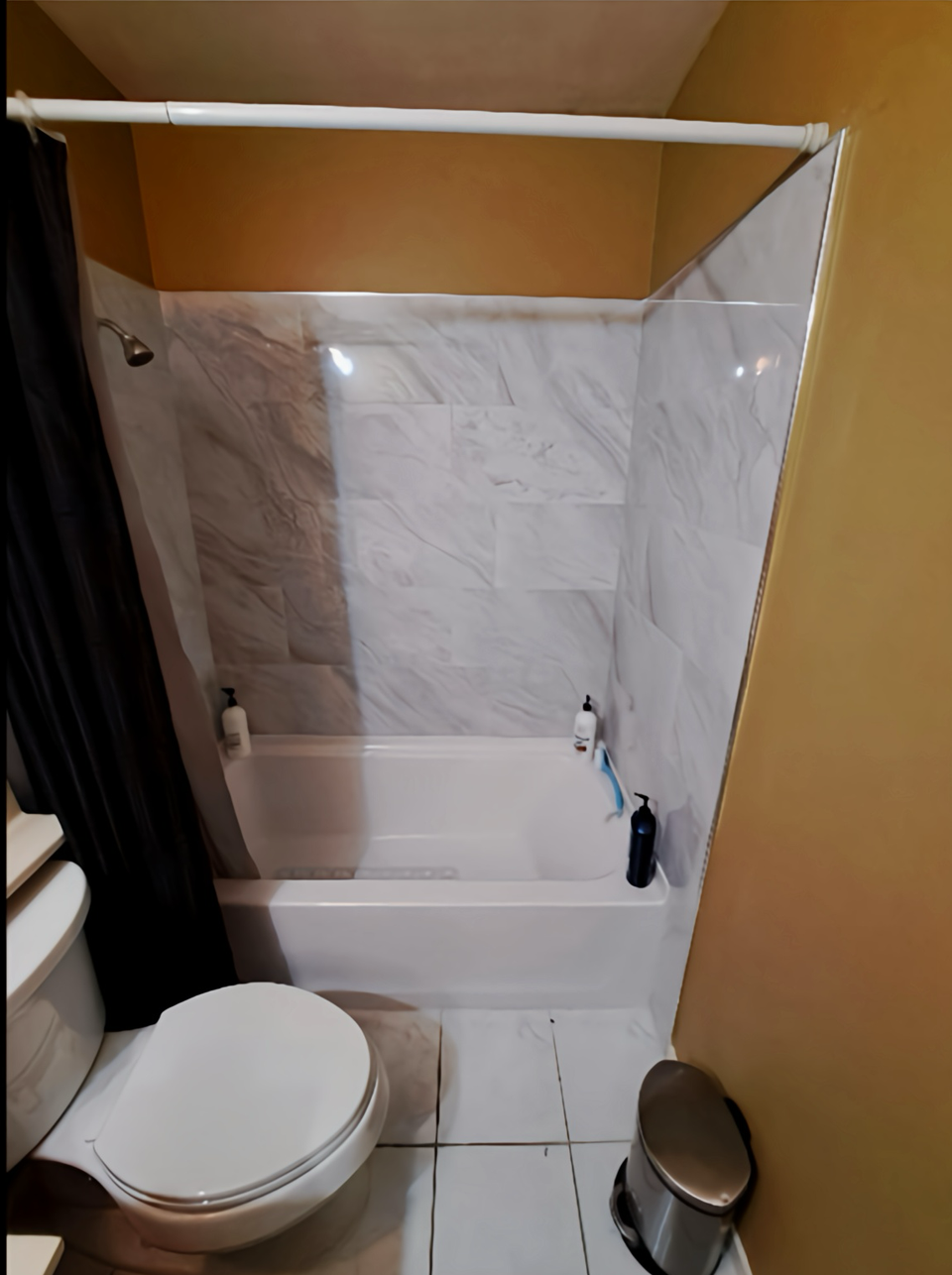 A bathroom with a toilet a sink and a bathtub