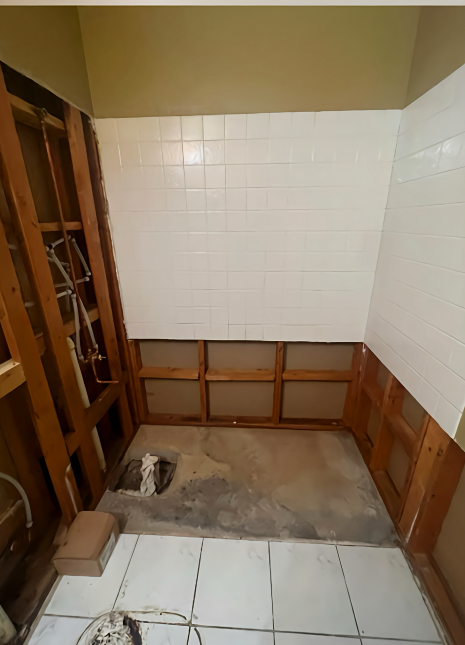 A bathroom sink is being remodeled with a hole in the floor