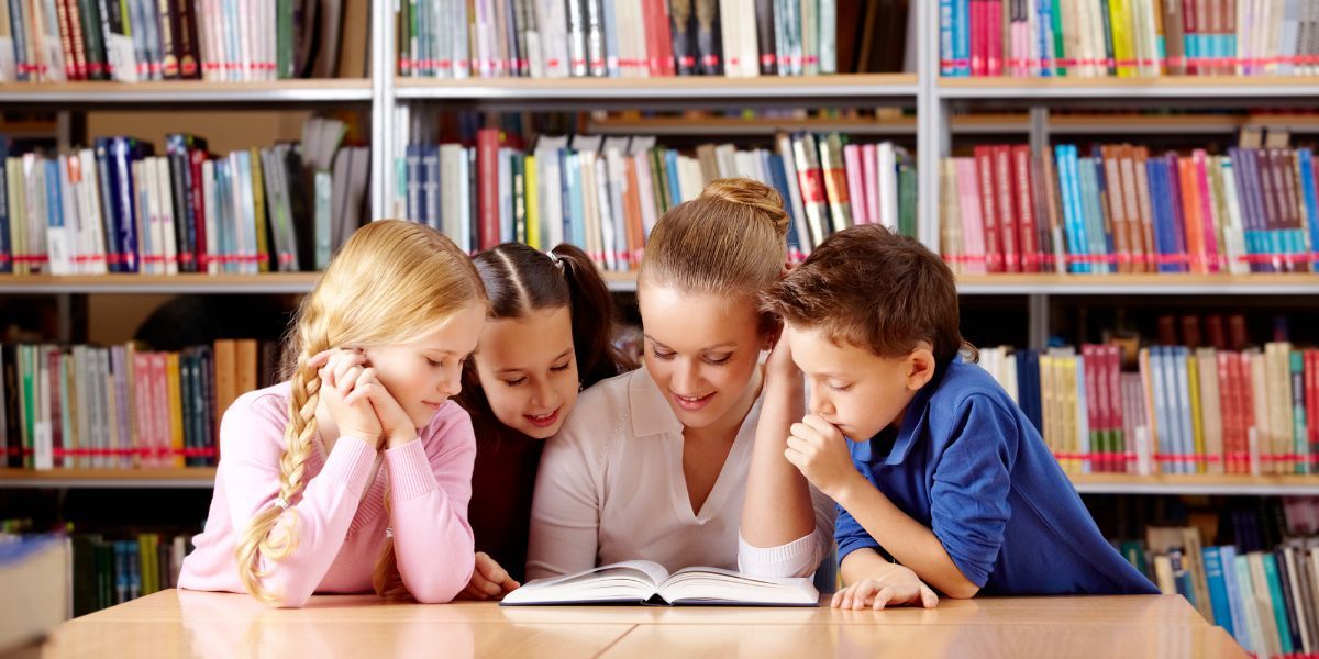 Teacher With Her Students in the Library — Fort Thomas, KY — Kids & Cribs Early Childhood Enrichment