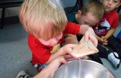 Kids Doing Cooking Activity — Fort Thomas, KY — Kids & Cribs Early Childhood Enrichment Center Kids Doing Cooking Activity — Fort Thomas, KY — Kids & Cribs Early Childhood Enrichment Center