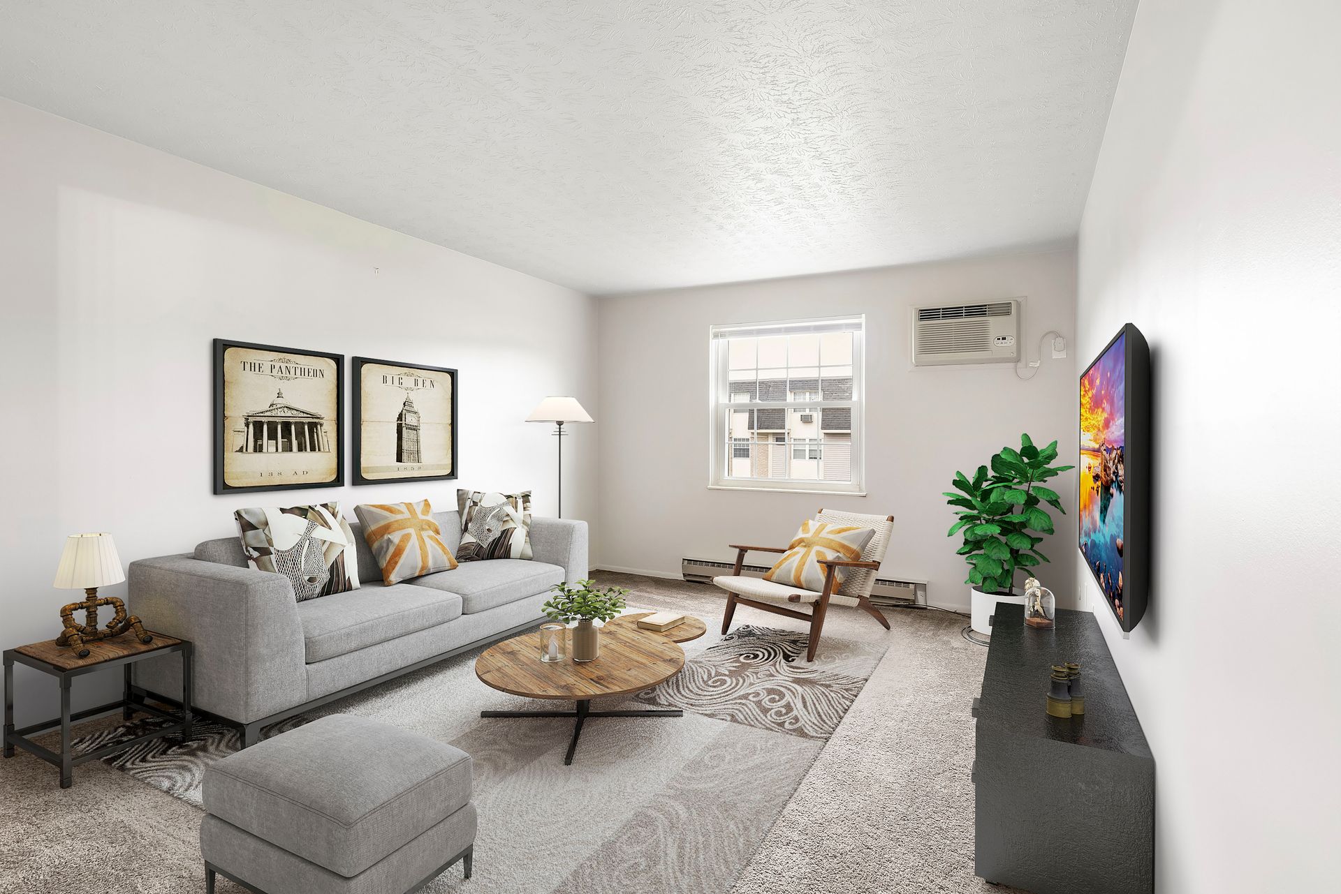 A living room with a couch , chairs , coffee table and television.