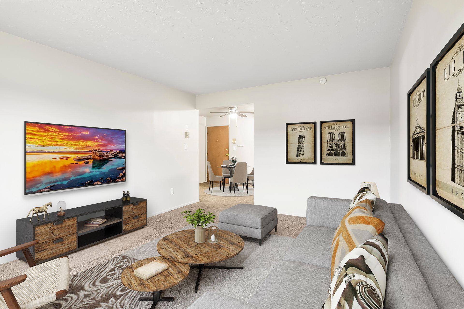 A living room with a couch , coffee tables , and a flat screen tv.