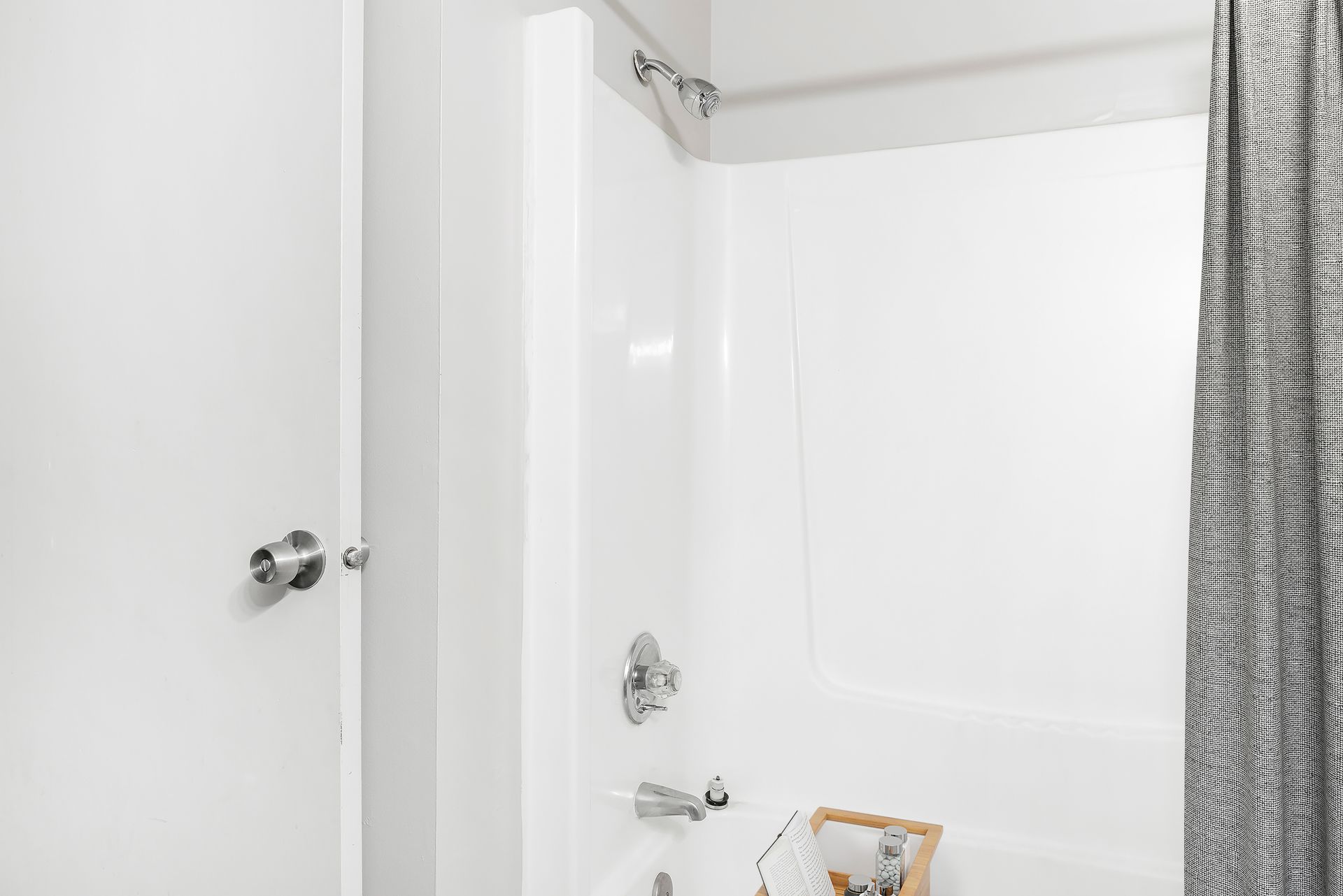 A bathroom with a shower curtain and a bathtub.
