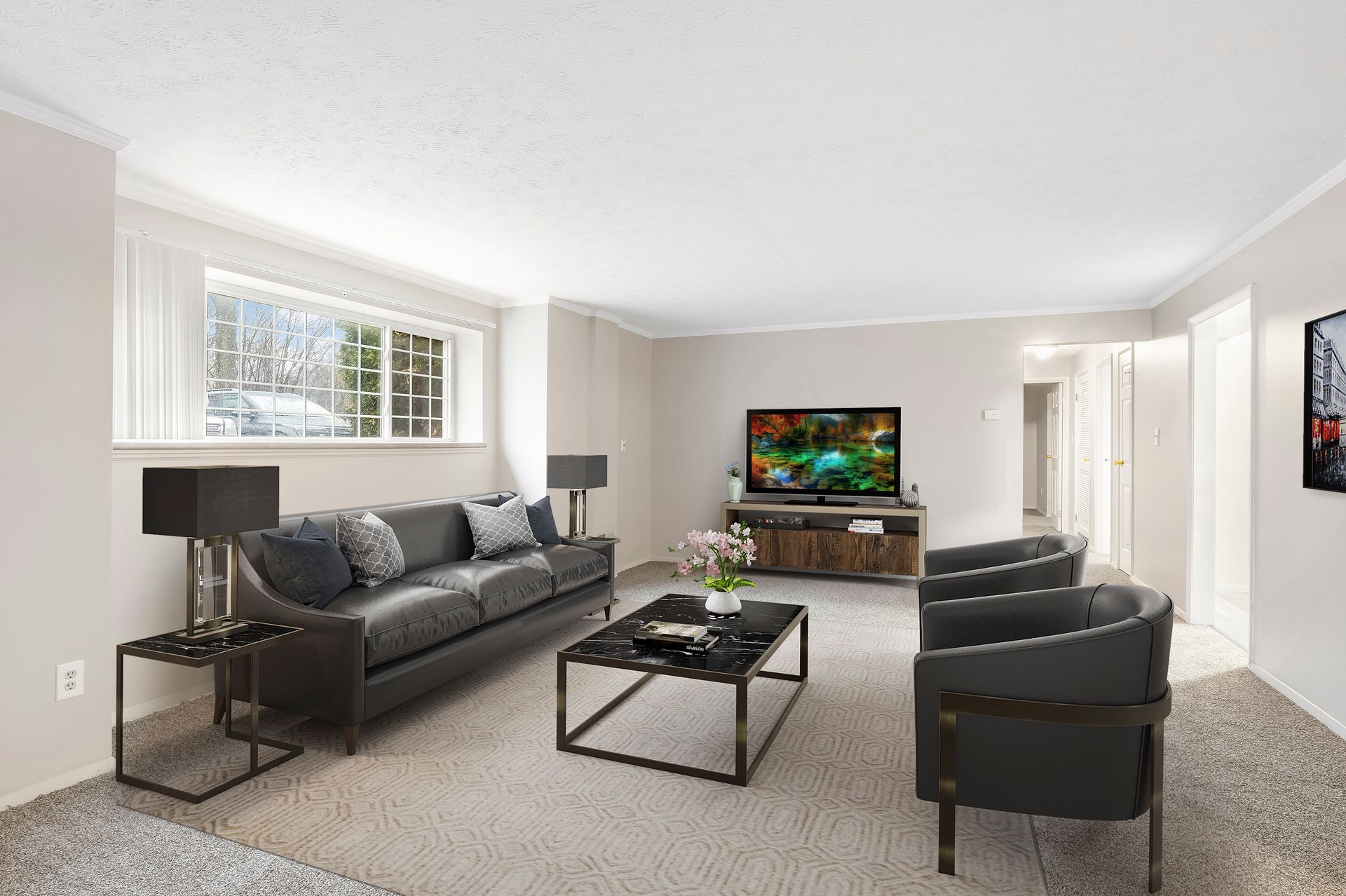 A living room with a couch , chairs , coffee table and television.