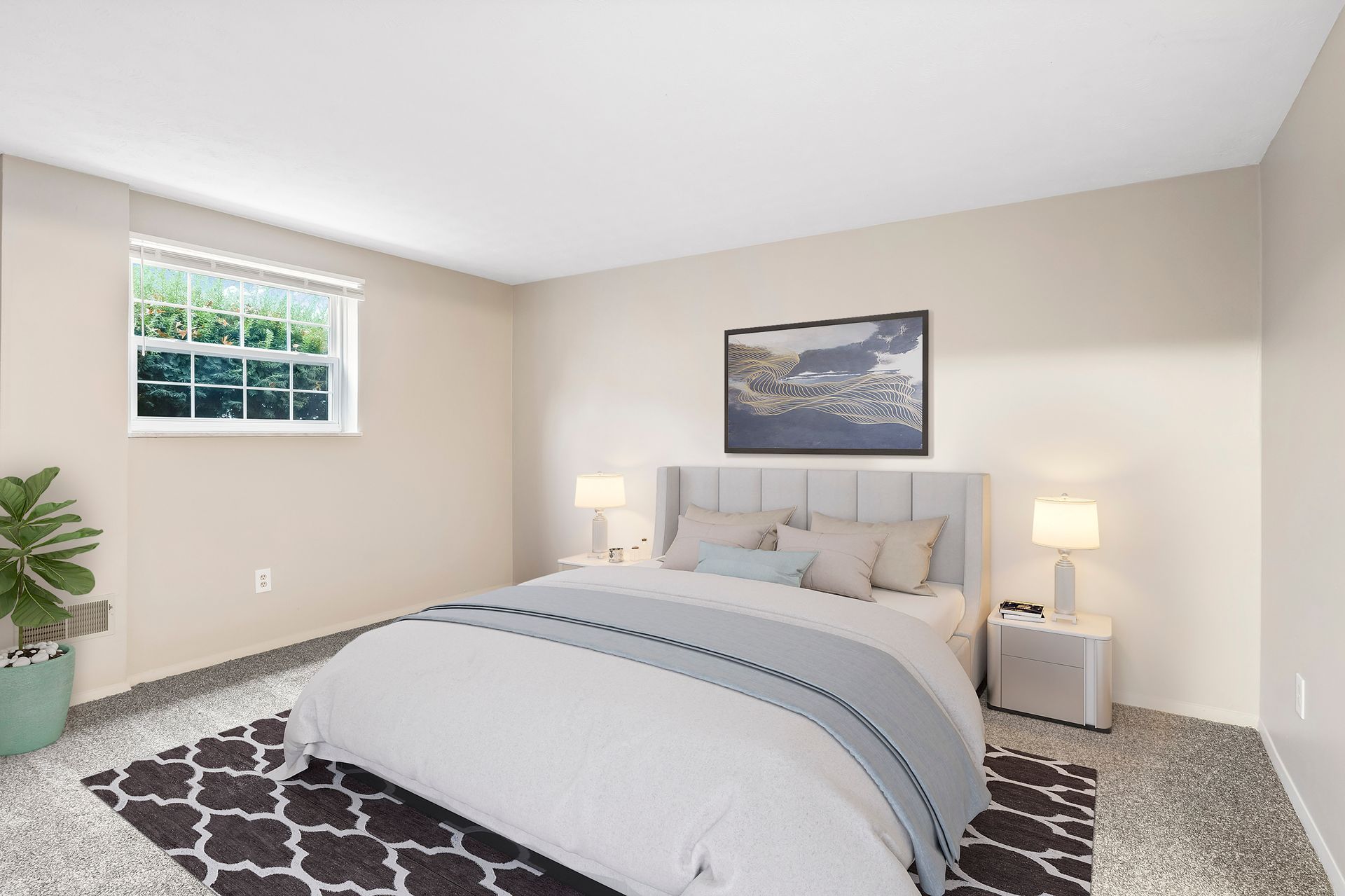 A bedroom with a large bed and a window.