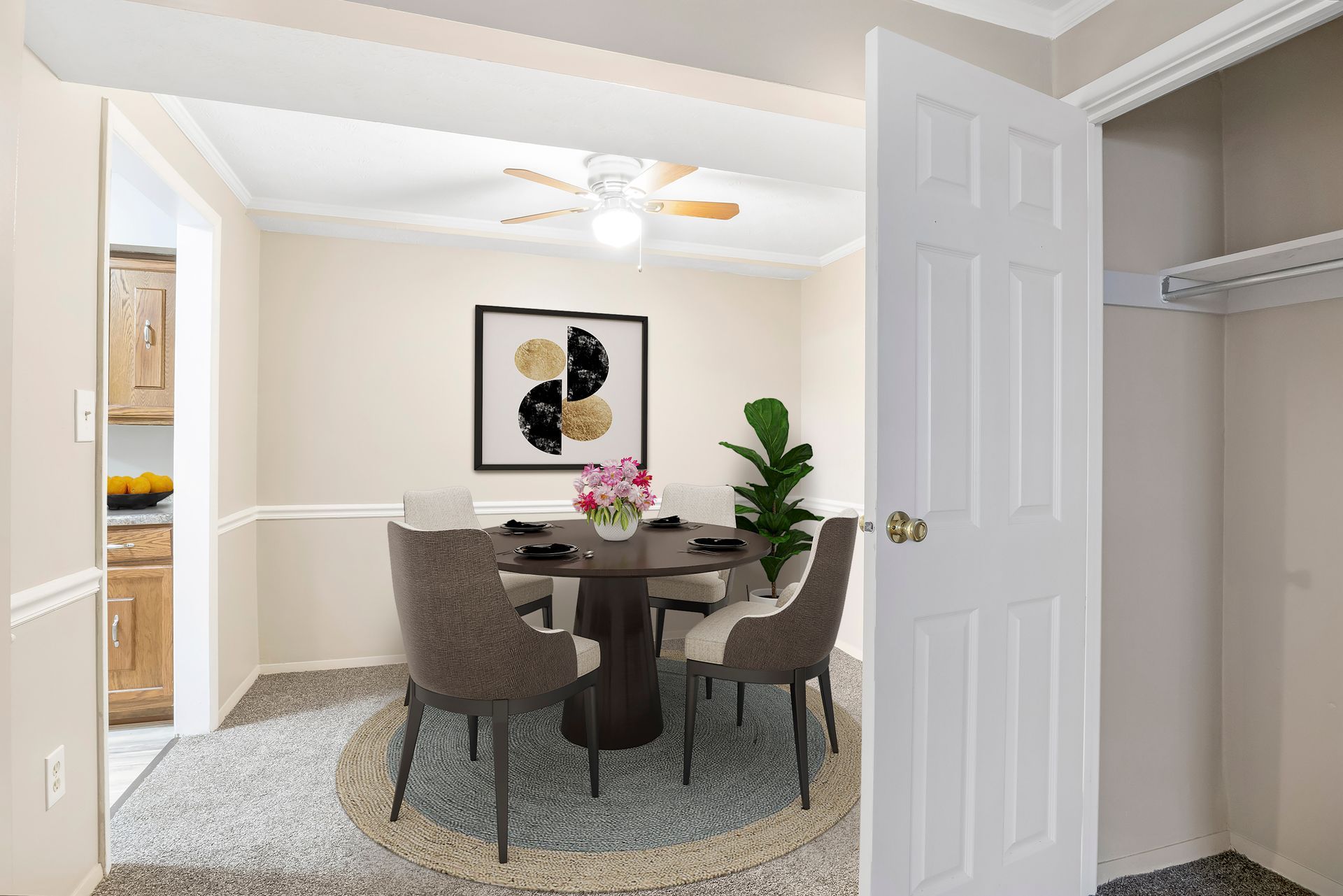 A dining room with a table and chairs and a ceiling fan.