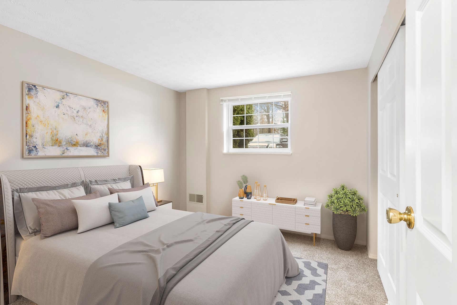 A bedroom with a large bed and a window.