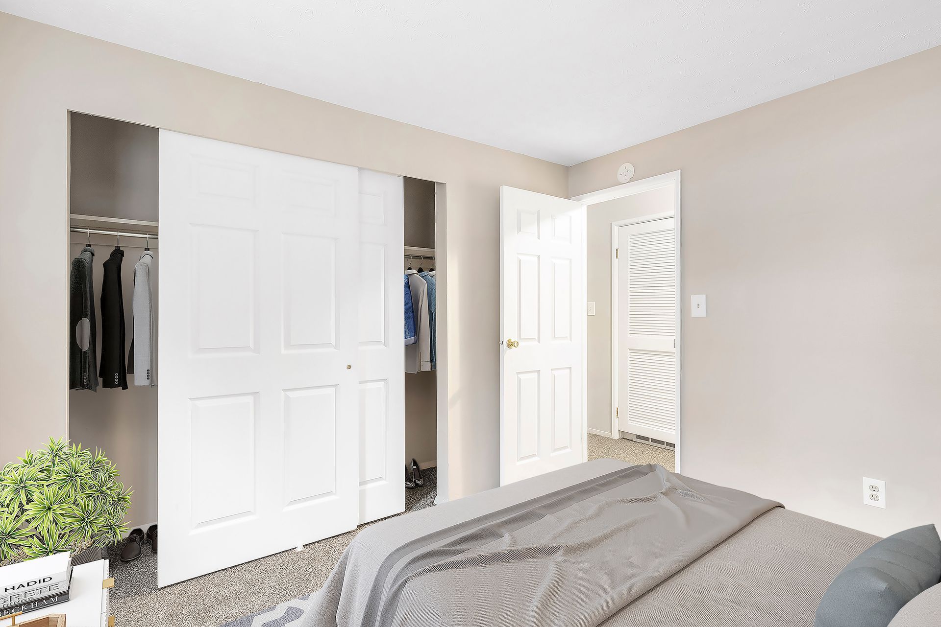 A bedroom with a bed and a walk in closet.