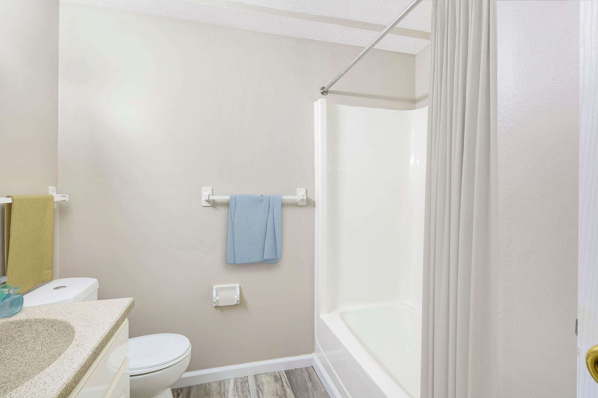 A bathroom with a toilet , sink , shower and bathtub.