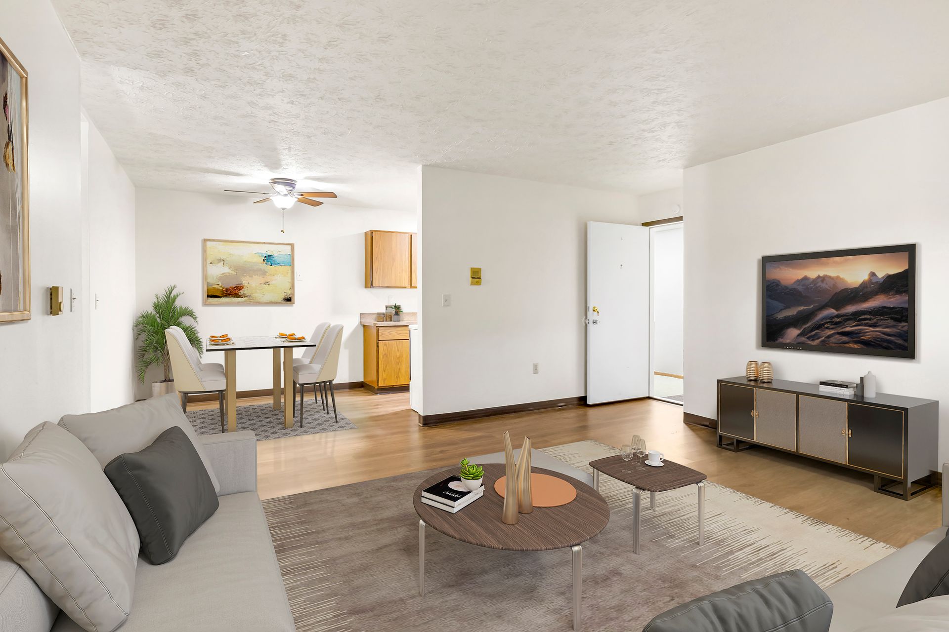 A living room with a couch , table , and television.