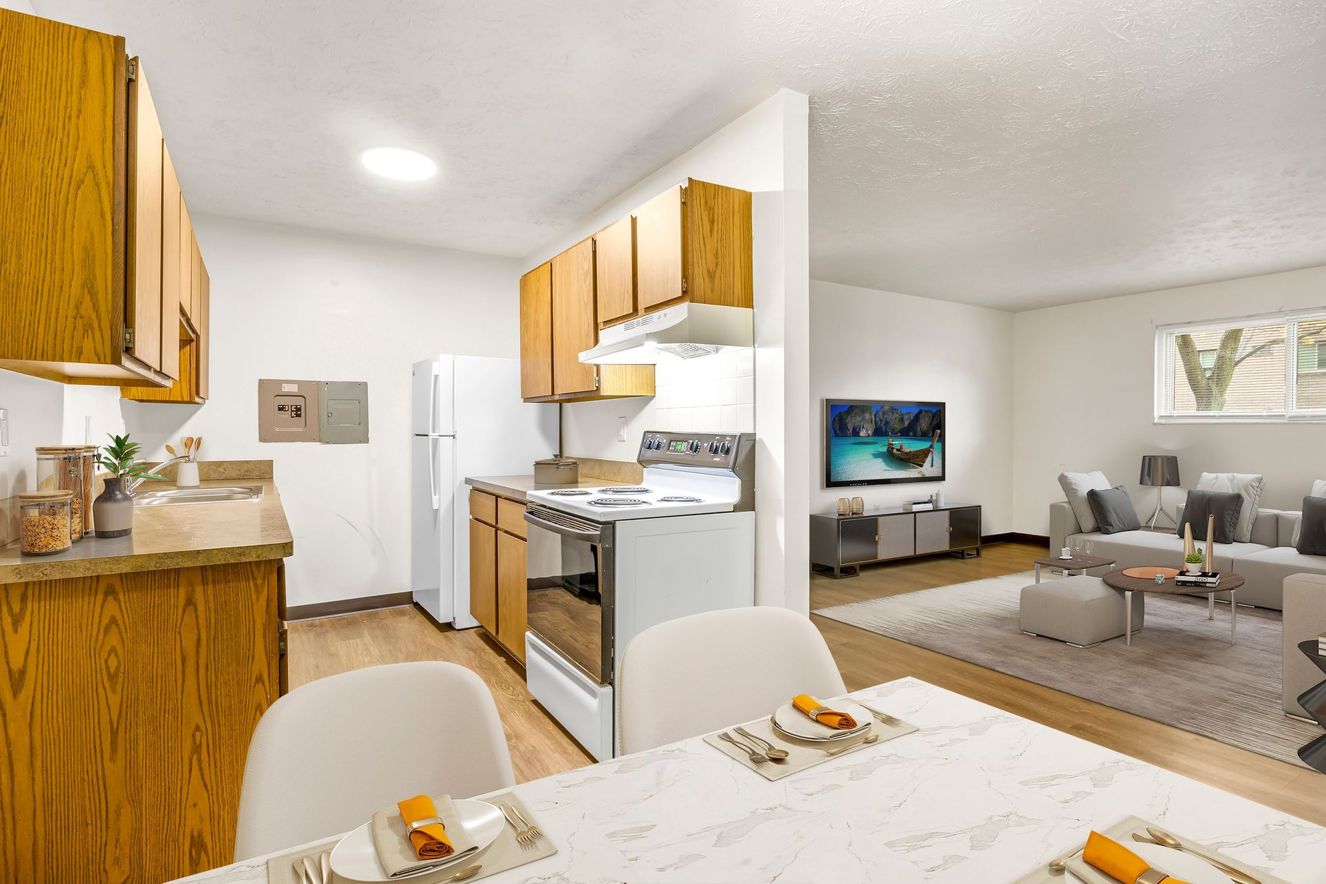 A kitchen and dining room in a house with a table and chairs.