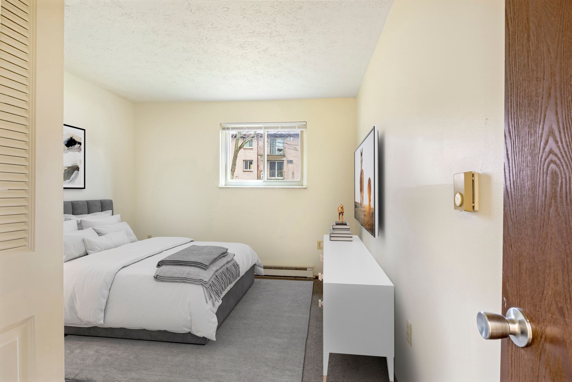 A bedroom with a bed , dresser , and television.