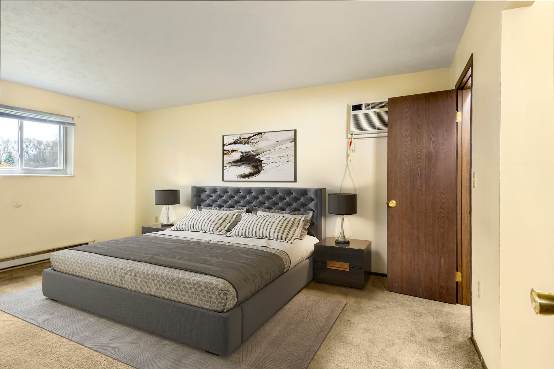 A bedroom with a large bed and a window