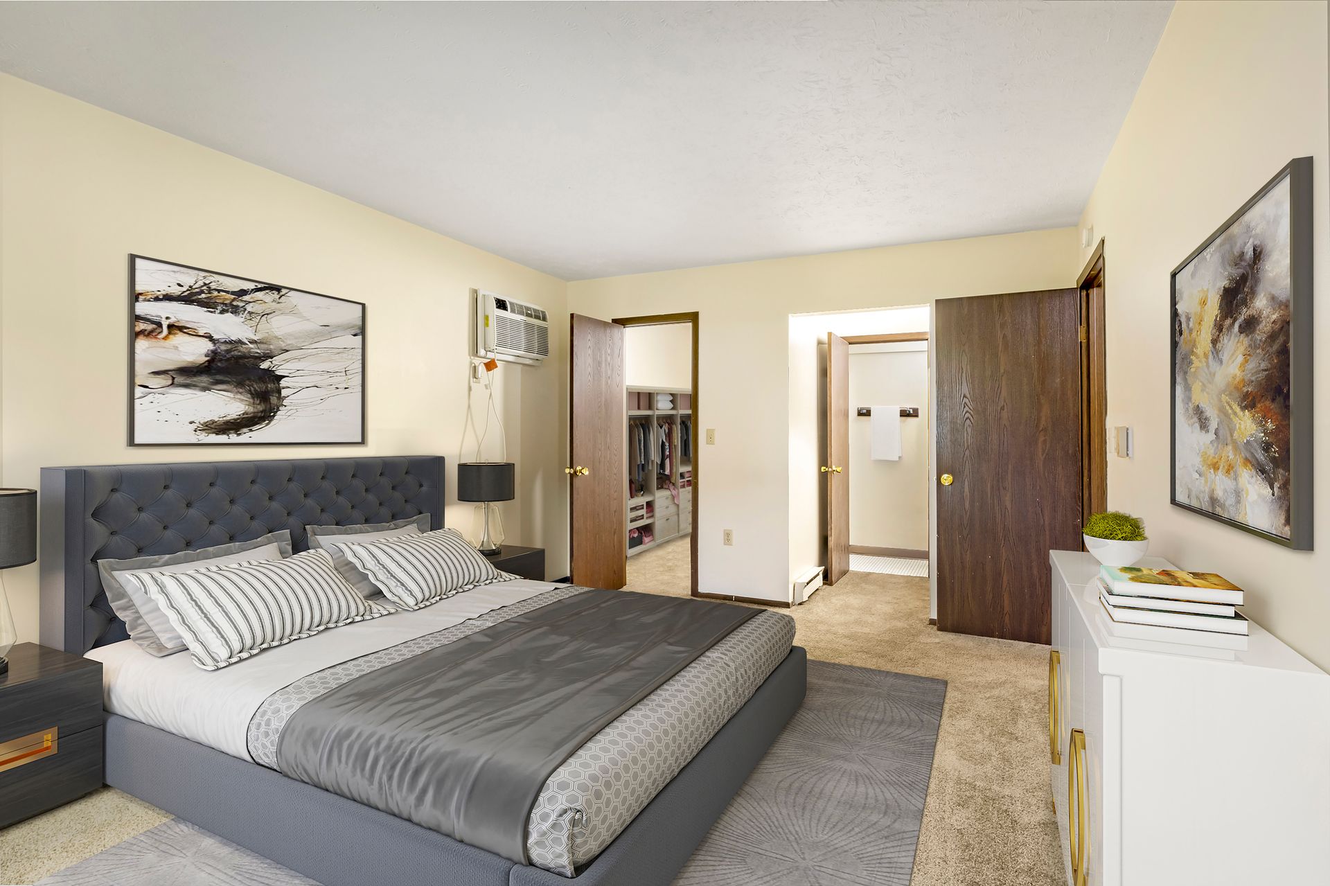 A bedroom with a large bed and a walk in closet.