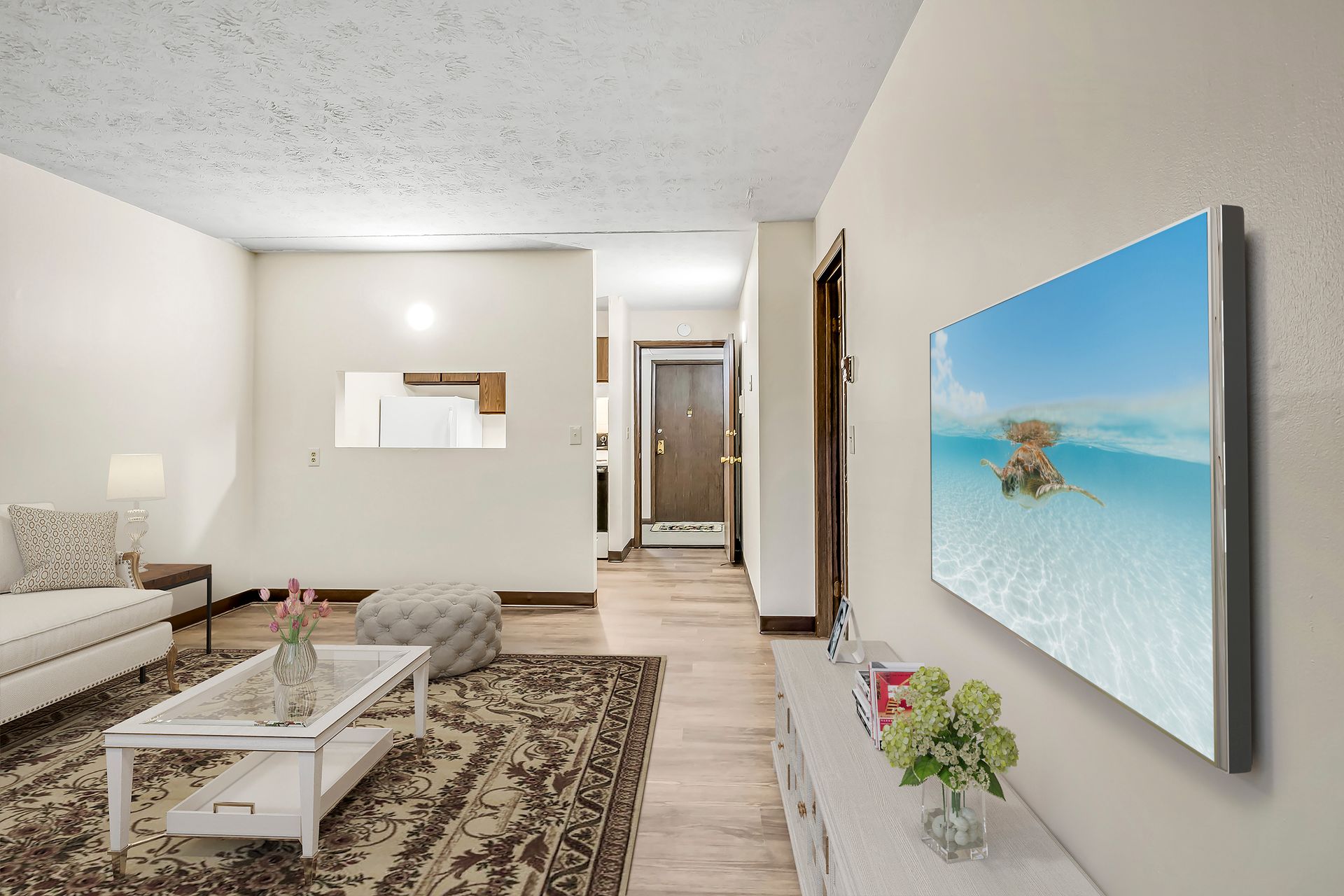 A living room with a flat screen tv on the wall
