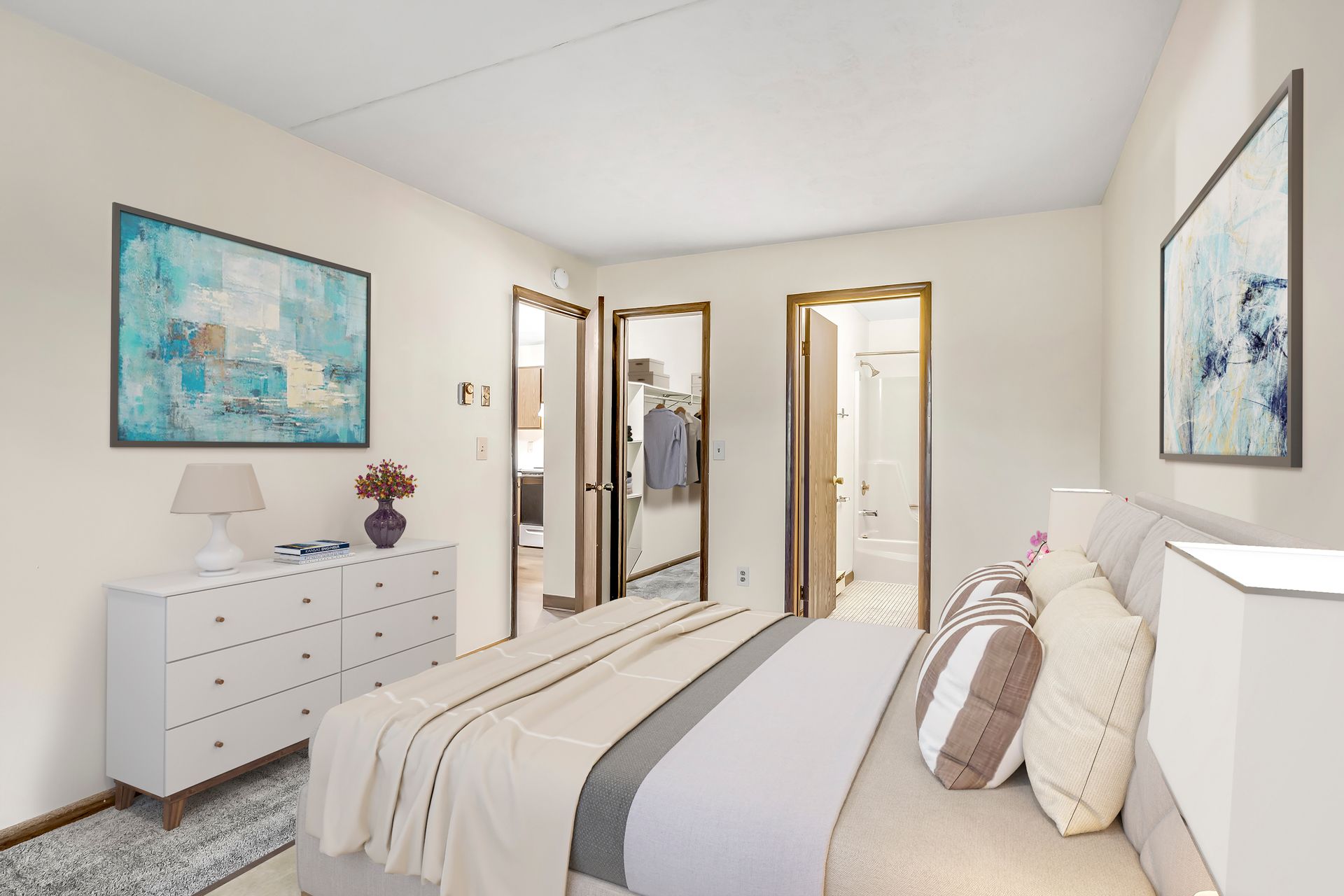 A bedroom with a large bed and a dresser.