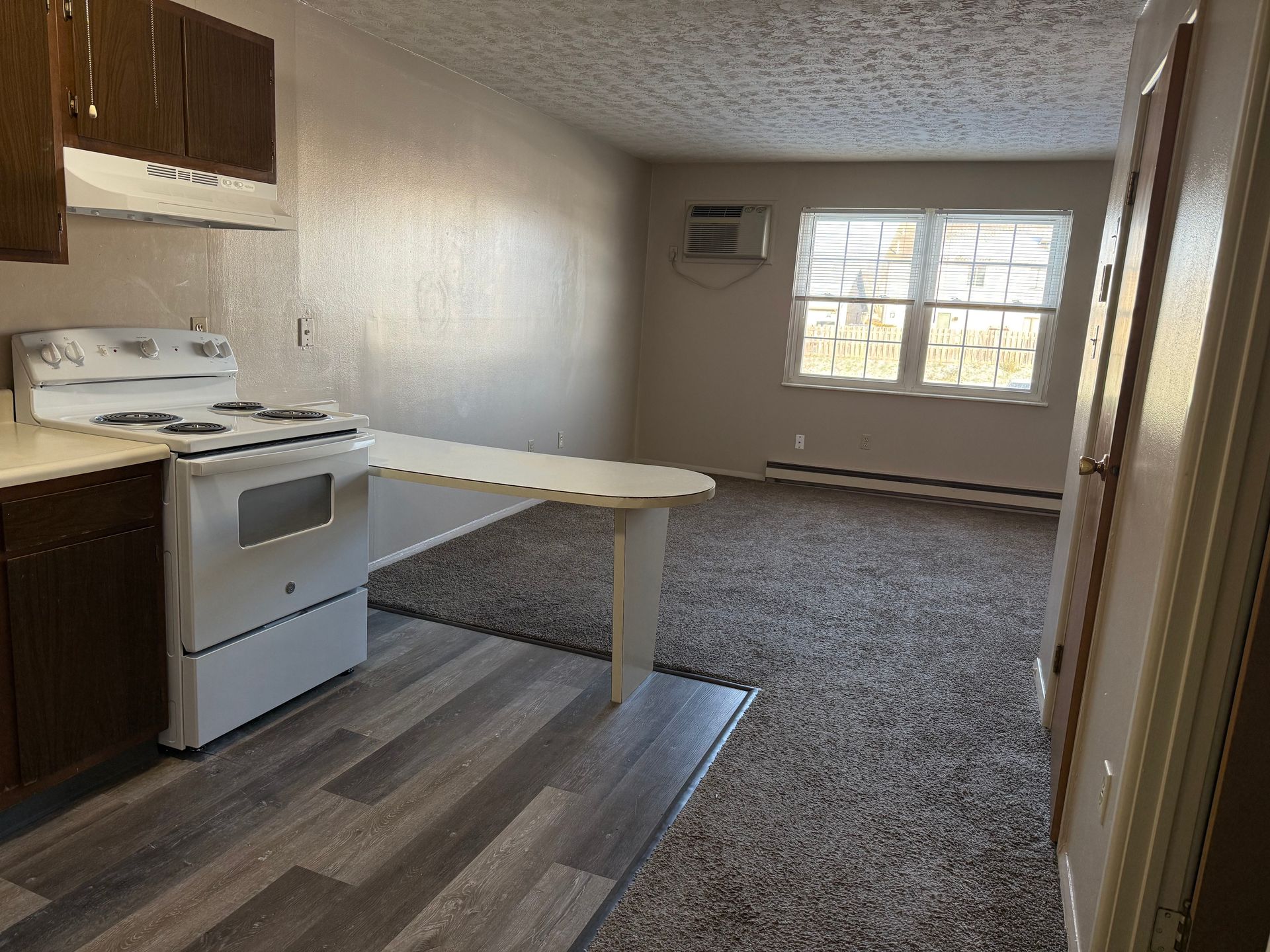 A kitchen with a stove and a table in it