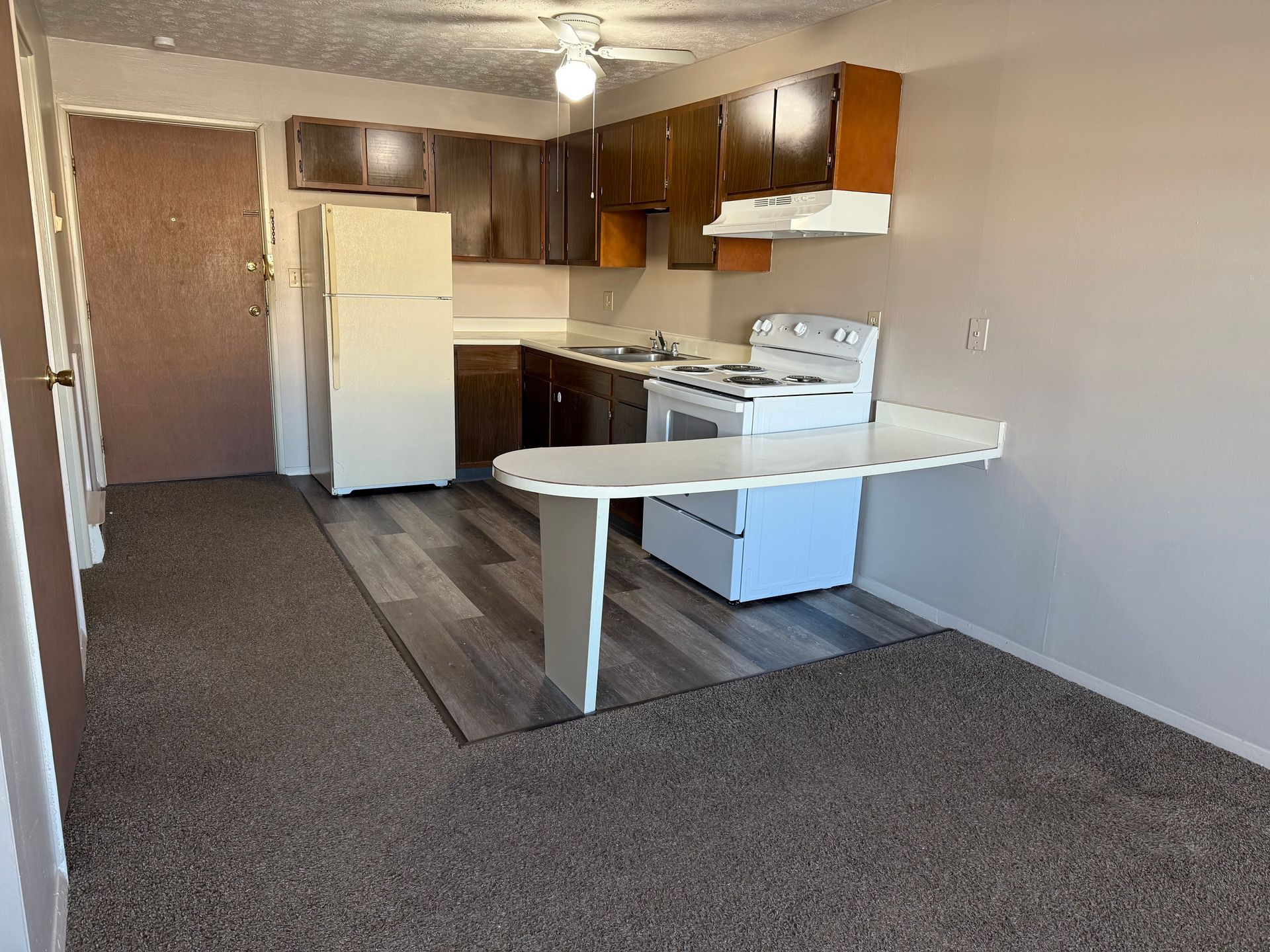 A kitchen with a refrigerator stove and a table
