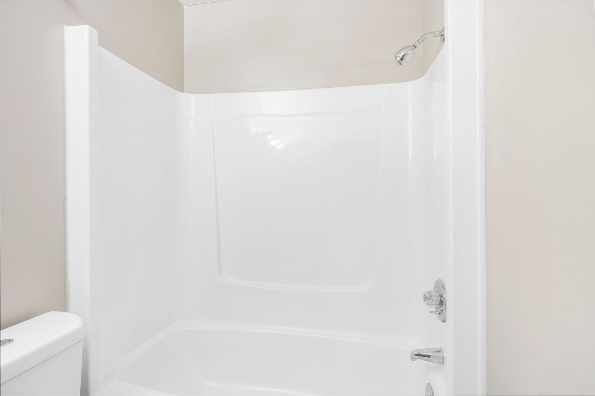 A bathroom with a tub , toilet and shower.