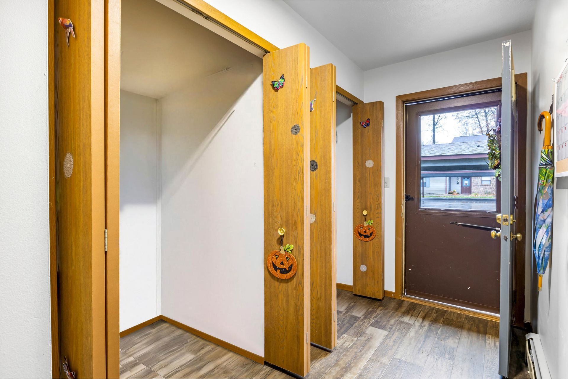 A hallway with a closet and a door in a house.