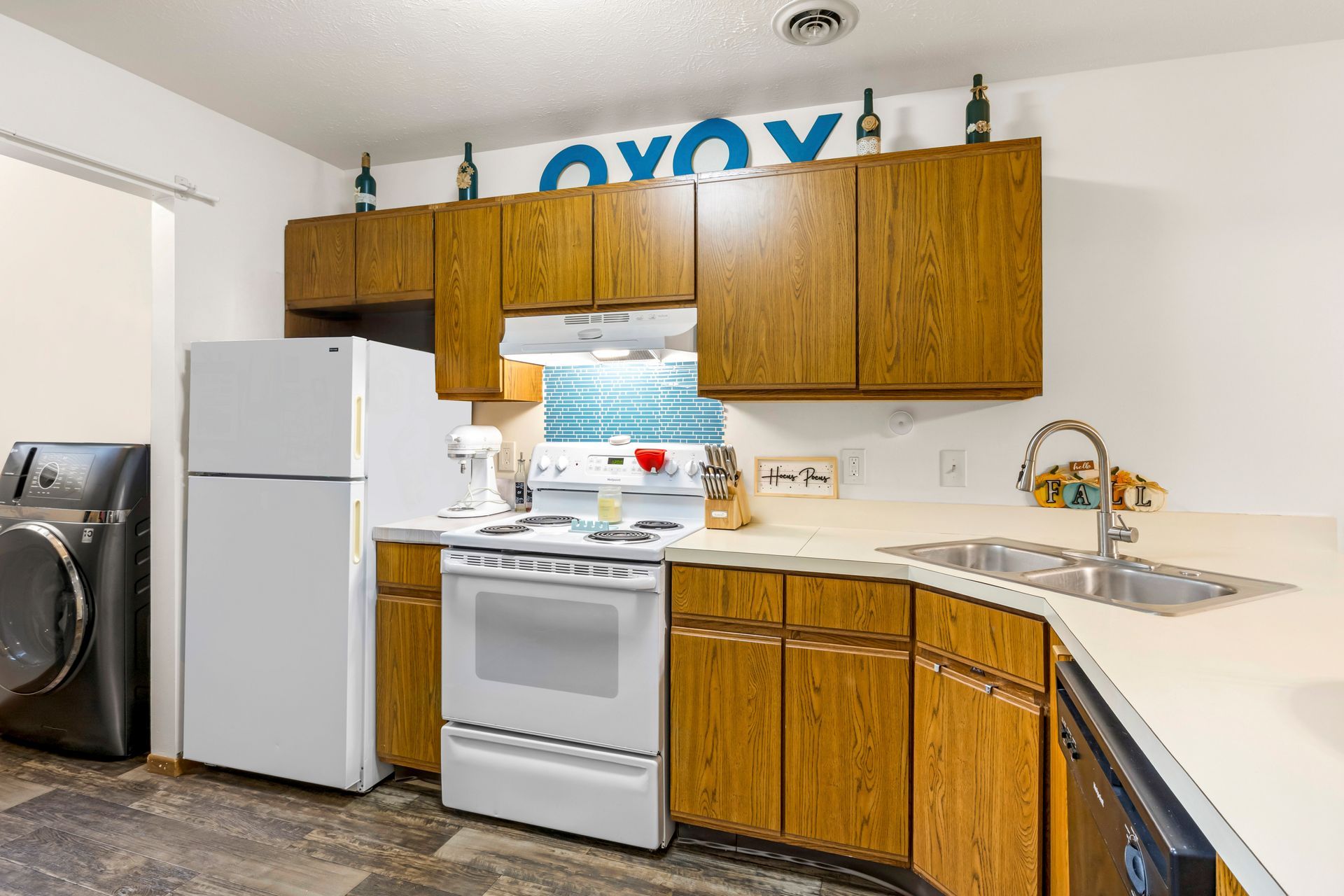 A kitchen with a refrigerator , stove , sink and dishwasher.