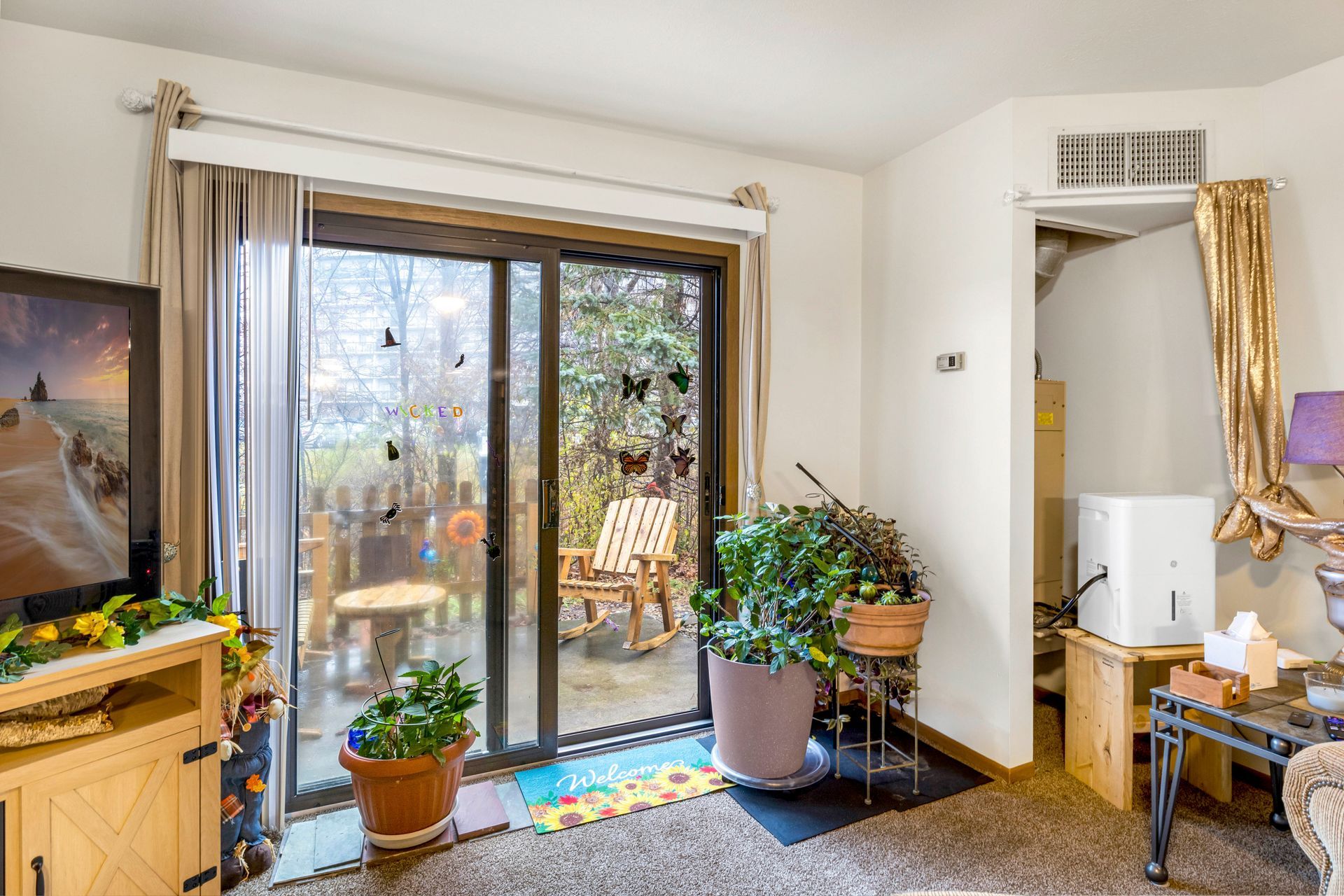 A living room with a sliding glass door leading to a patio.