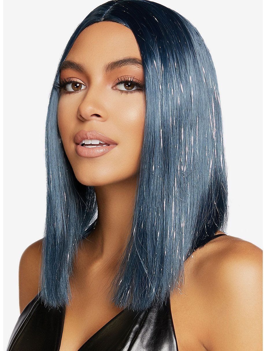 A woman wearing a blue wig and a black dress.