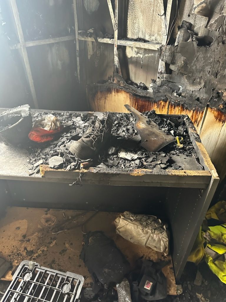 A room damaged from fire with some stuff