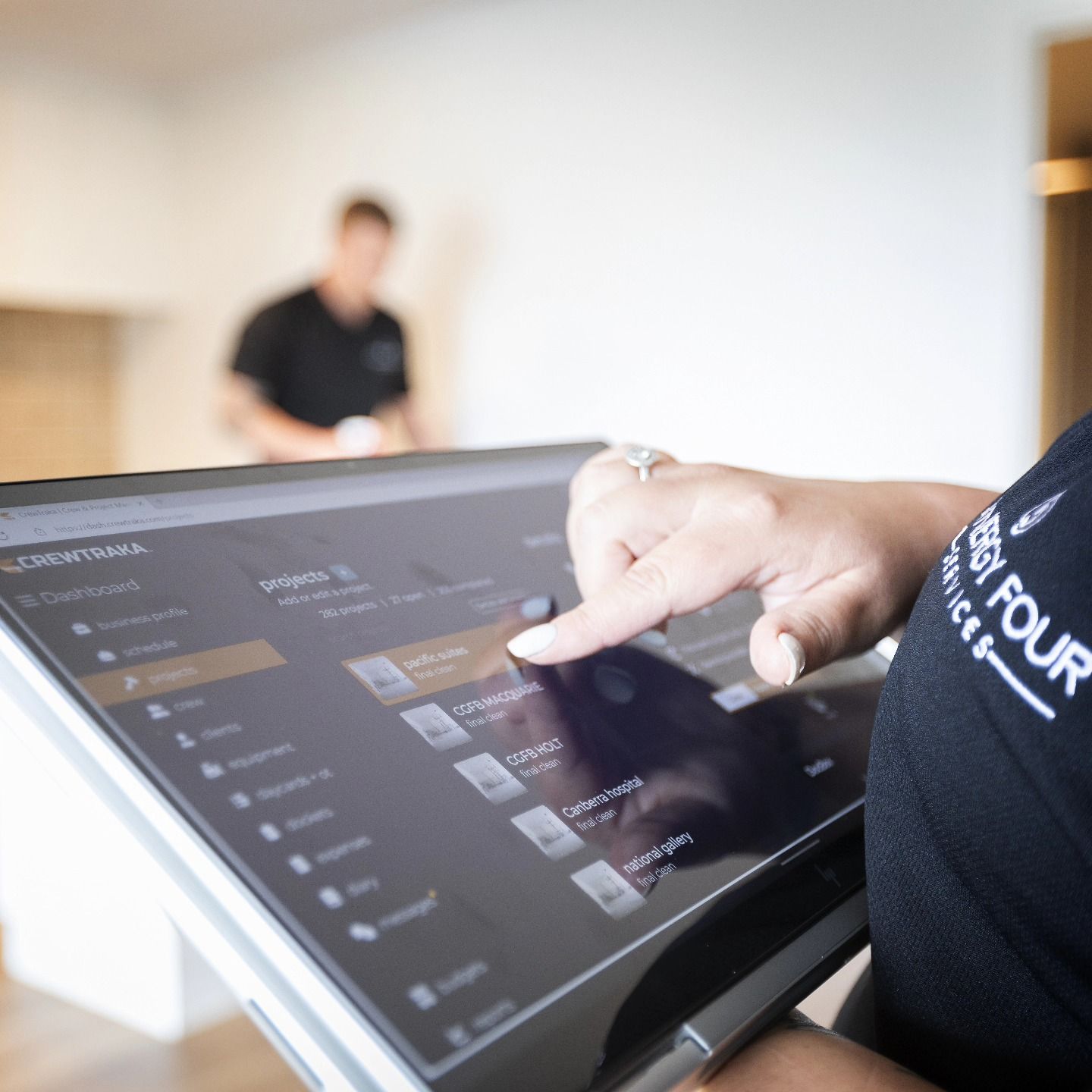 A person wearing a black shirt with the word four on it