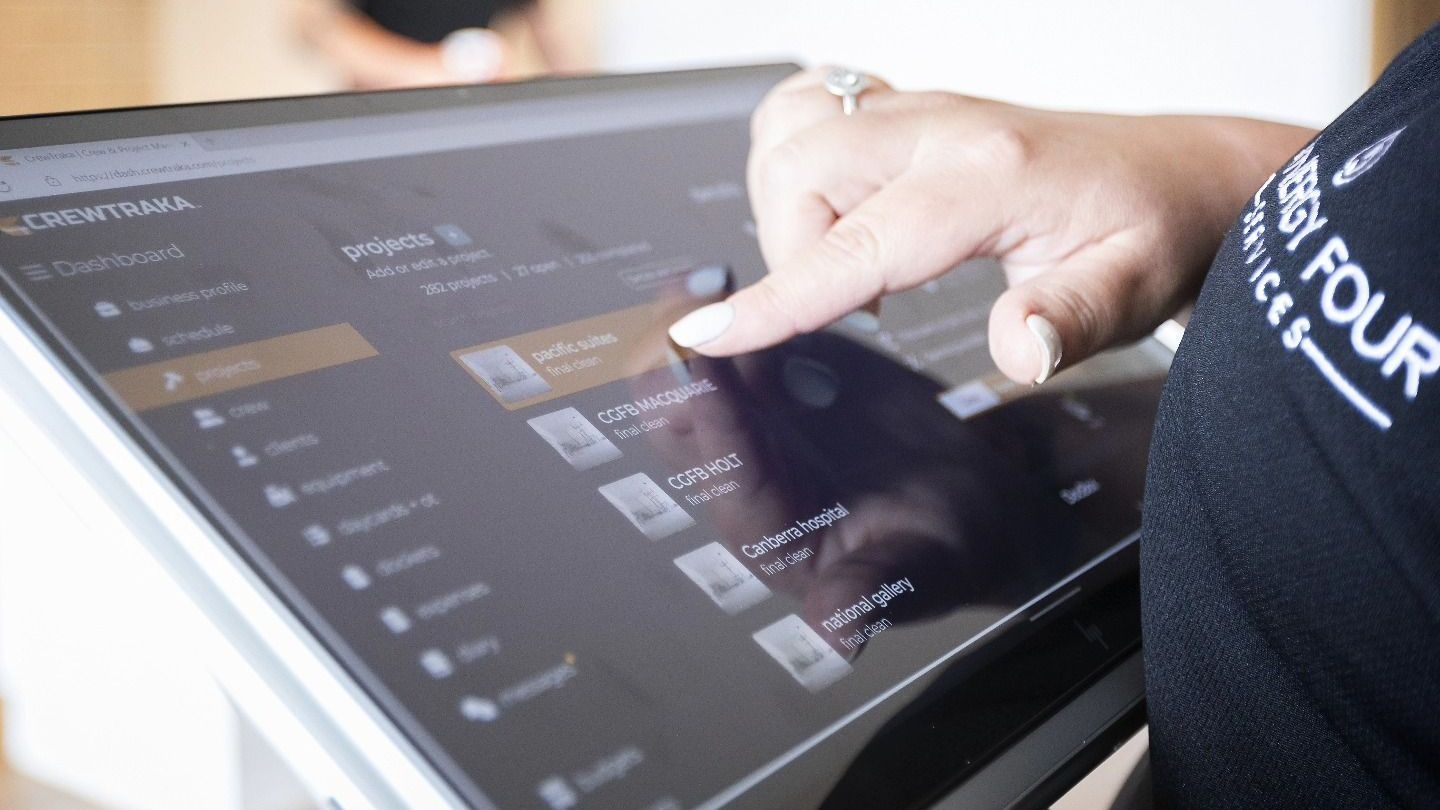 A person is using a tablet computer with their finger on the screen.