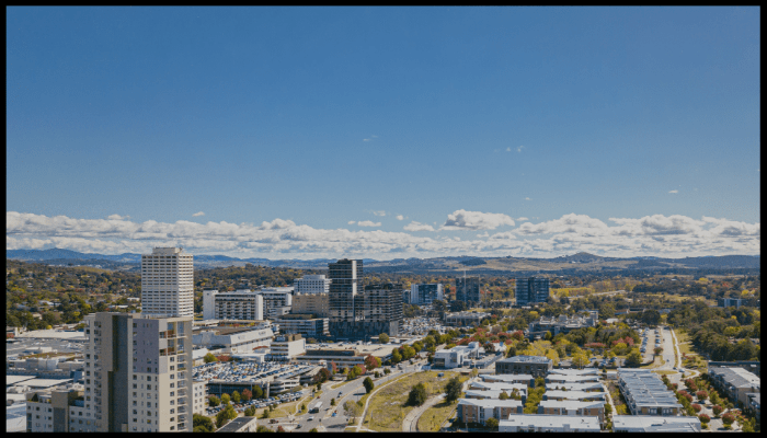 An aerial view of a city with mountains in the background.