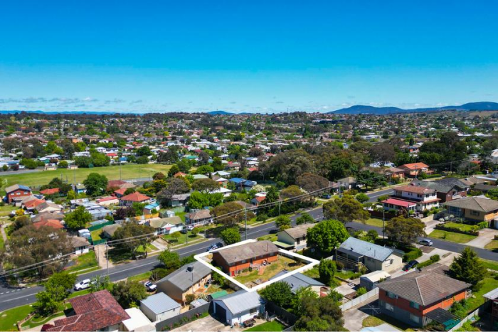 An aerial view of a city with mountains in the background.
