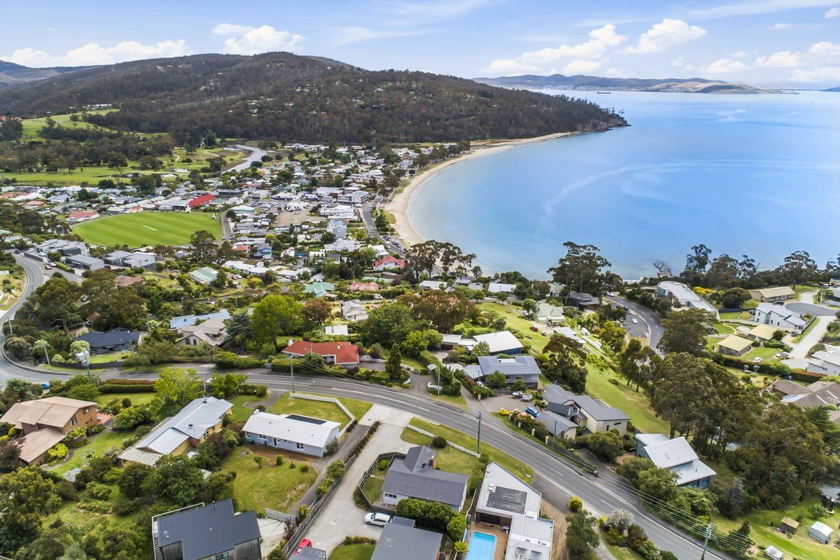 An aerial view of a small town next to a body of water.